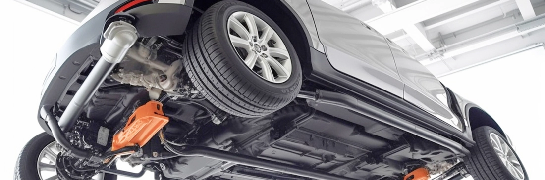 Car on a lift. View from the bottom, underside is visible.